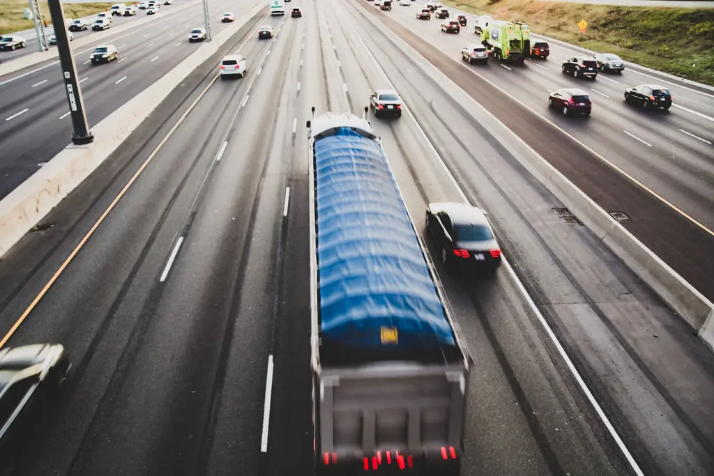 Semi-truck driving in traffic on a Southern California freeway