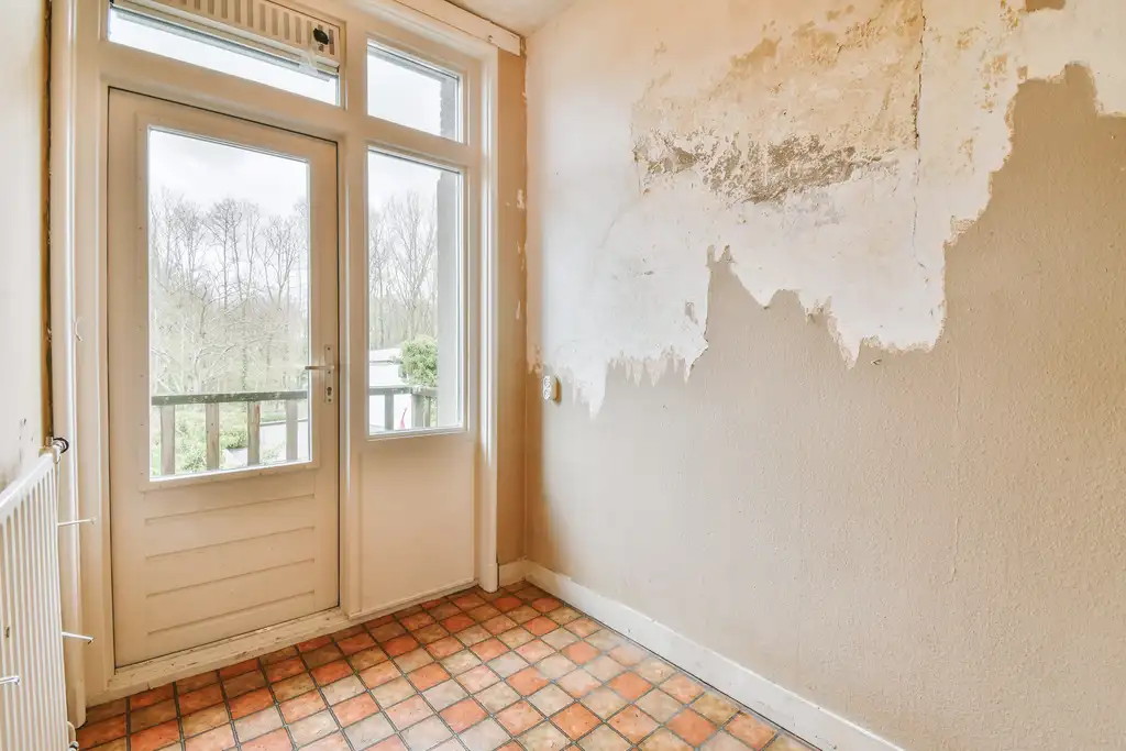 Adjuster photographing smoke damage inside a house for a property claim
