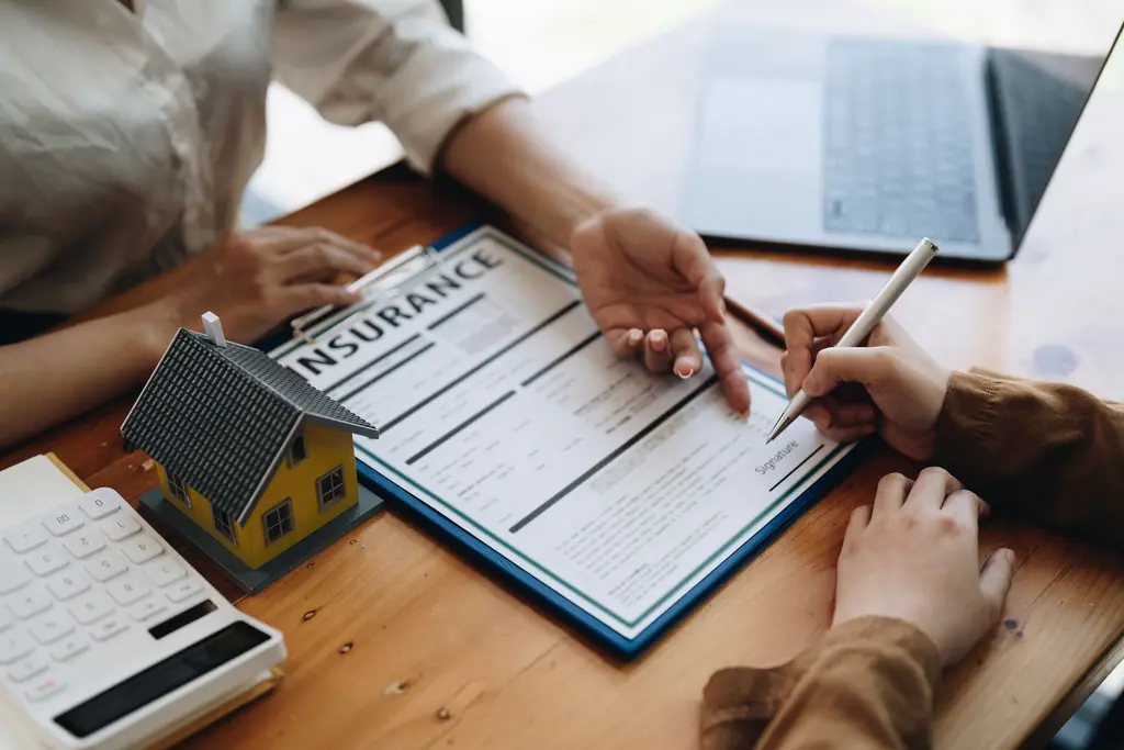 Attorney and client reviewing a property insurance policy and repair estimates