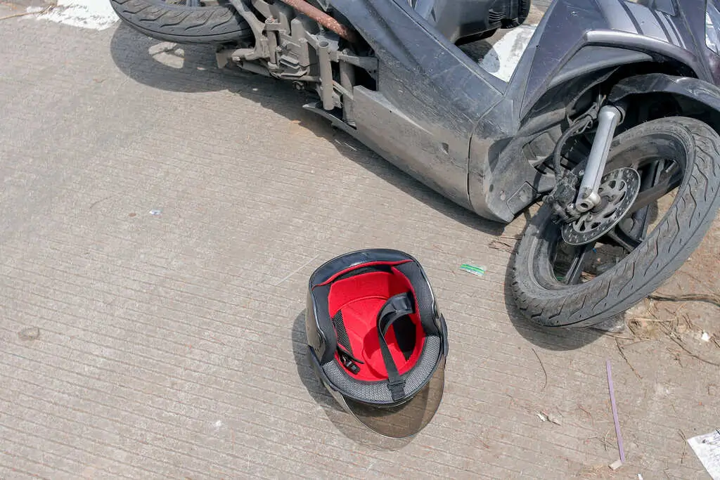Scuffed motorcycle helmet and riding jacket kept after a crash