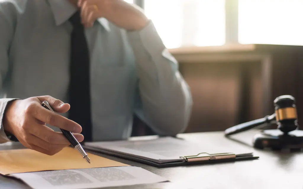 Attorney and client reviewing a truck accident claim file at a desk